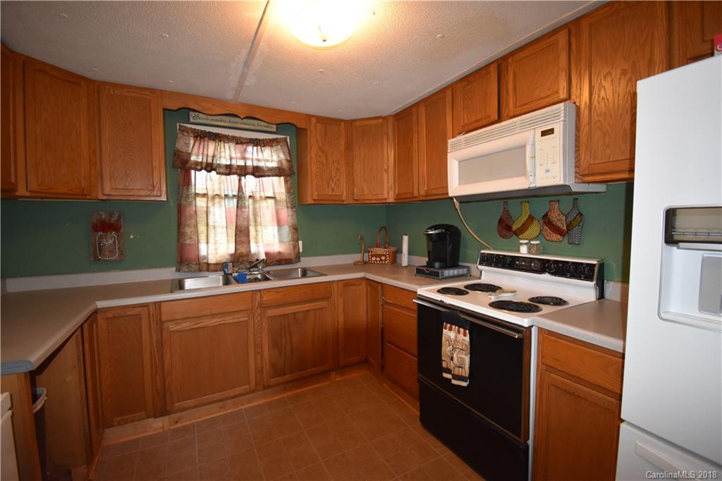 463 Lindsey Loop Road Fletcher, NC 28732 - Photo 17 of 27 a kitchen with stainless steel appliances granite countertop a stove a sink and a microwave