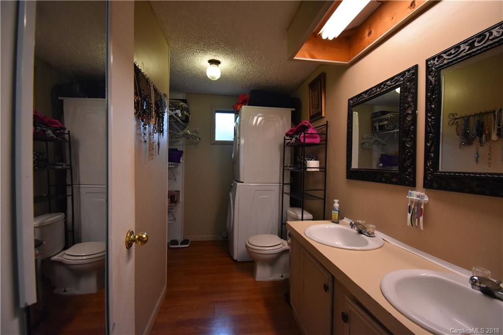 463 Lindsey Loop Road Fletcher, NC 28732 - Photo 20 of 27 a bathroom with a granite countertop sink toilet and shower