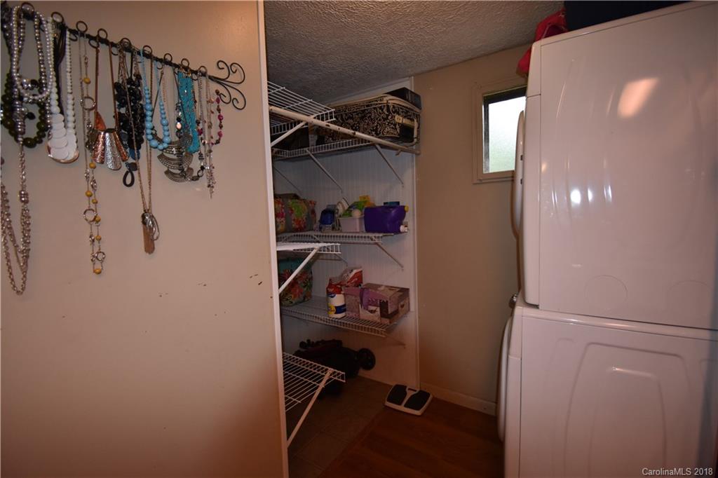 463 Lindsey Loop Road Fletcher, NC 28732 - Photo 21 of 27 a view of walk in closet with clothes and shoes