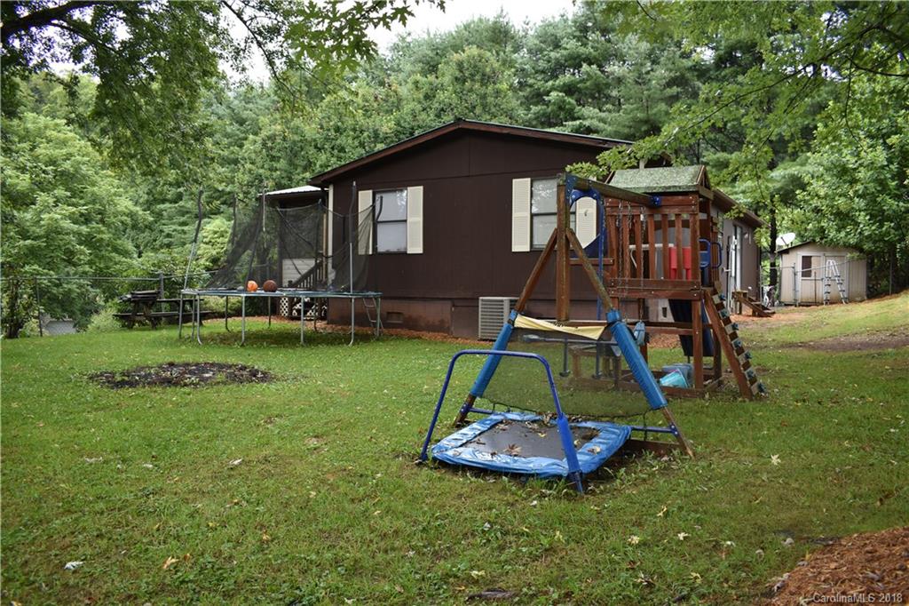 463 Lindsey Loop Road Fletcher, NC 28732 - Photo 5 of 27 a view of a small house with a yard