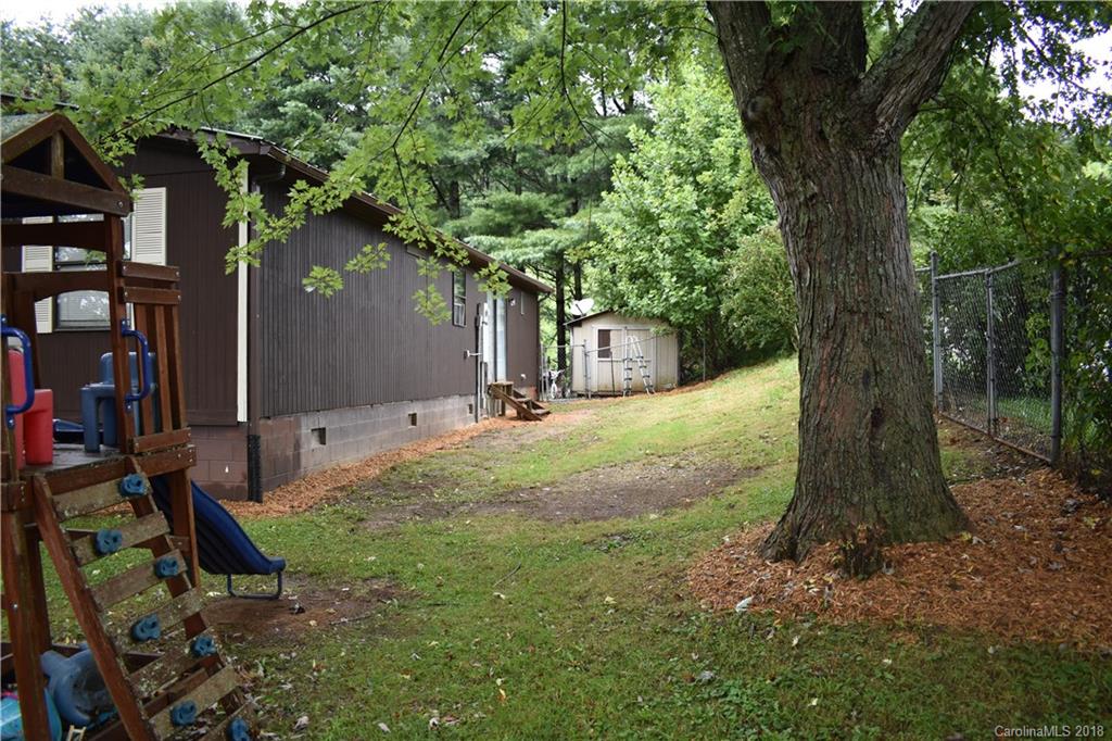 463 Lindsey Loop Road Fletcher, NC 28732 - Photo 6 of 27 a backyard of a house with lots of green space