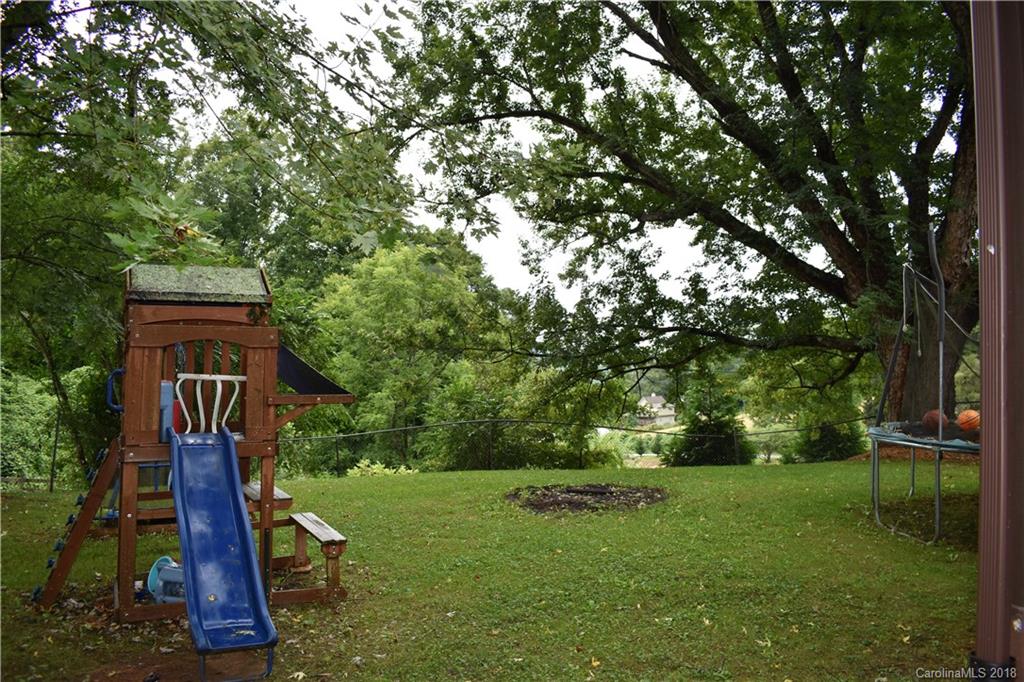 463 Lindsey Loop Road Fletcher, NC 28732 - Photo 7 of 27 a backyard of a house with lots of green space