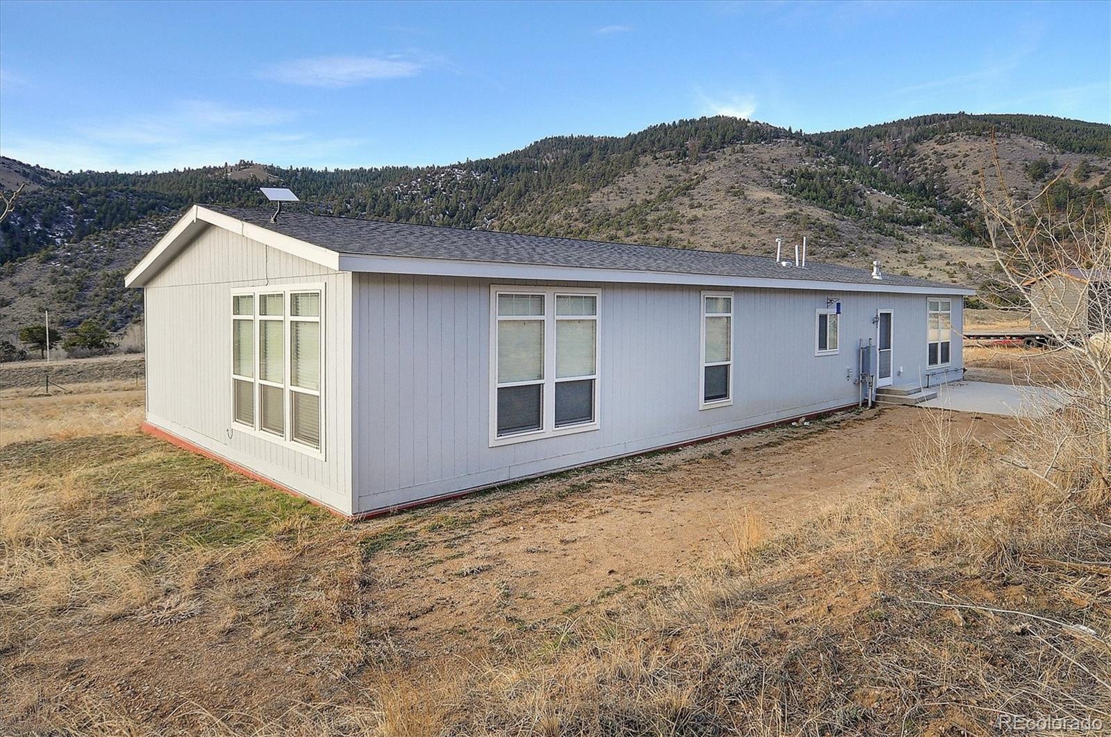 16554 Rocky Mountain Road Salida, CO 81201 - Photo 31 of 33 front view of a house with a yard