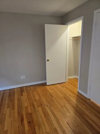 a view of an empty room and wooden floor