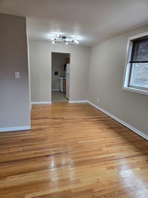 7019 North Ridge Avenue, Unit 3A Chicago, IL 60660 - Photo 6 of 11 a view of a livingroom with a chandelier