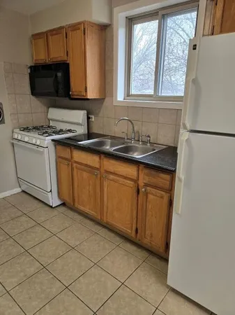a kitchen with a sink cabinets and a microwave