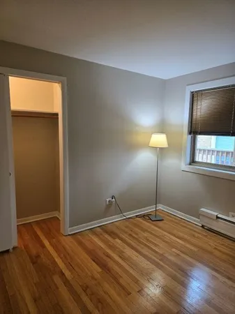 a room with a bed and a lamp