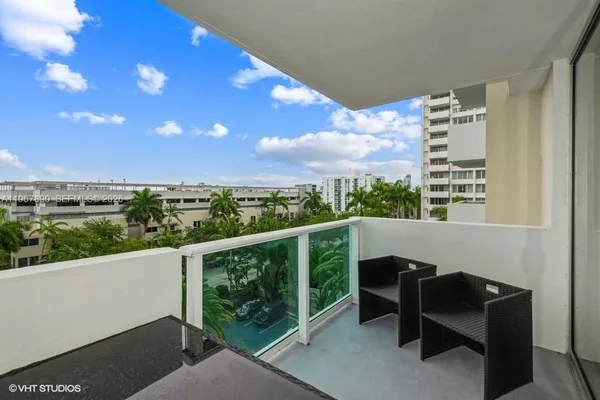 a view of a balcony with furniture
