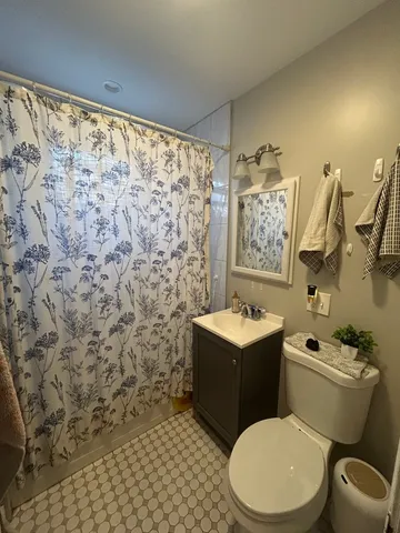 a white toilet sitting next to a bathroom sink