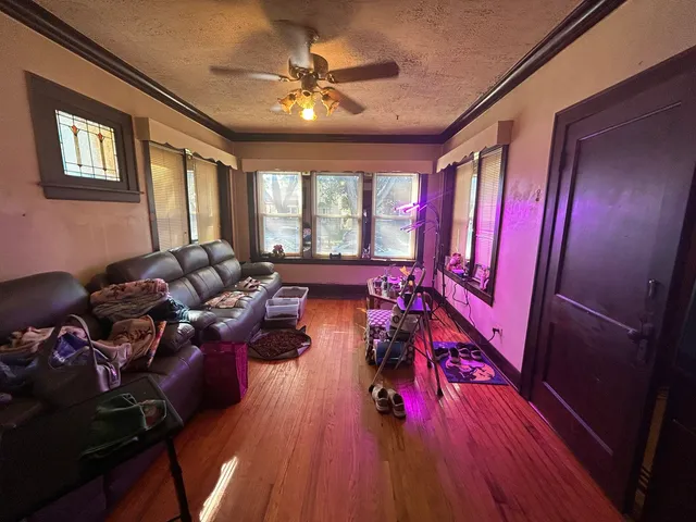 a living room with furniture fireplace and wooden floor