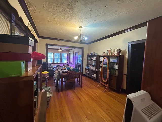 a view of a dining room with furniture and chandelier