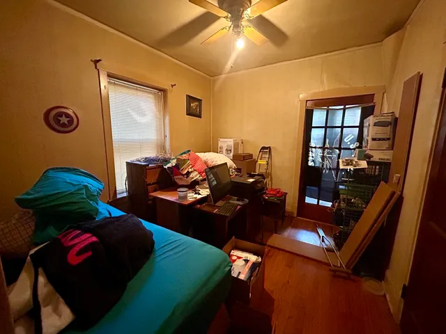 a bedroom with bed and a window