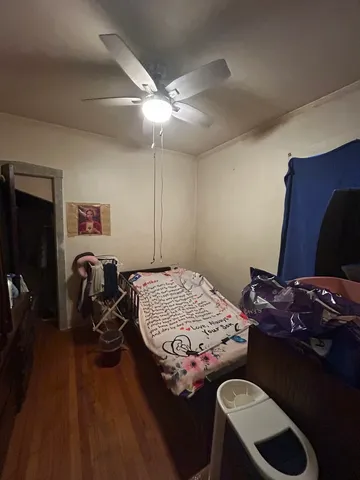 a bedroom with furniture and wooden floor