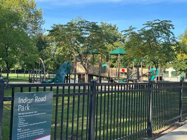 a green field with trees in the background