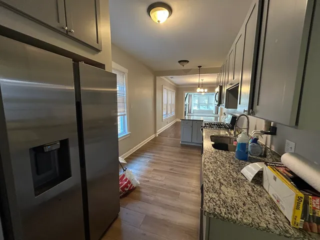 a living room with couches and furniture with kitchen view