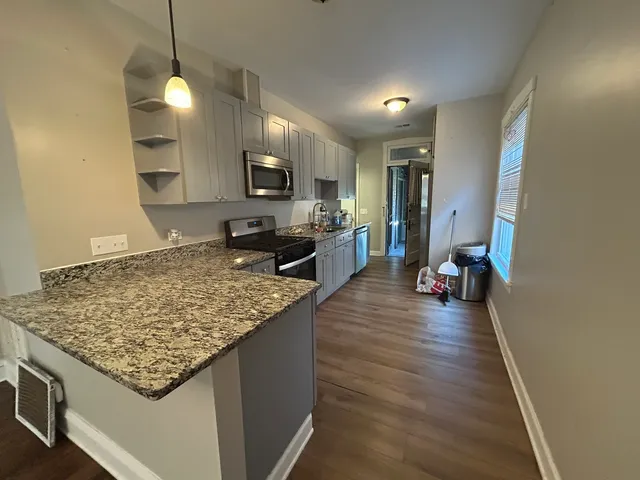 a kitchen with sink and refrigerator