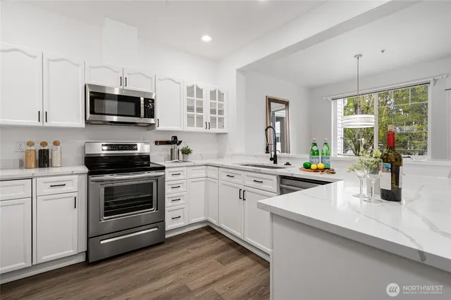 a kitchen with a sink stove and microwave