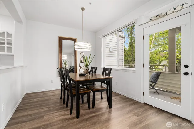 a view of a dining room with furniture window and wooden floor