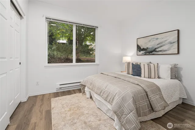 a bedroom with a bed and a painting on the wall