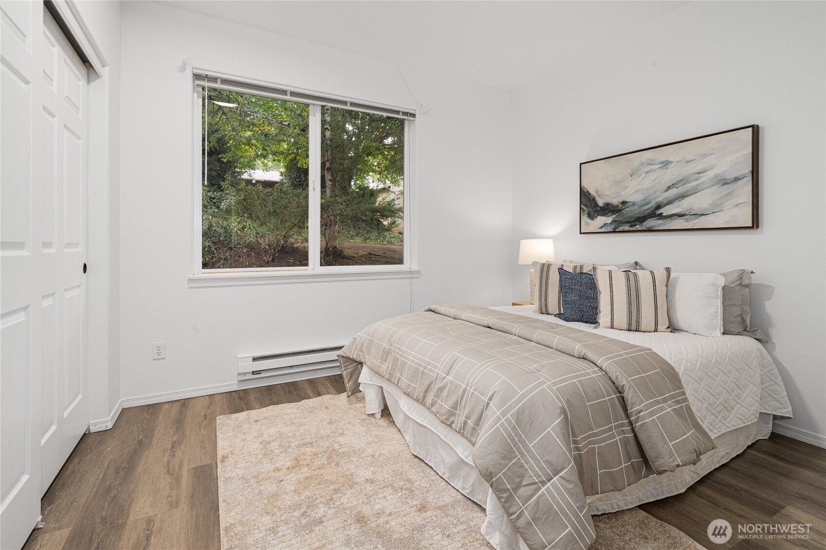 7583 Old Redmond Road, Unit A203 Redmond, WA 98052 - Photo 21 of 29 a bedroom with a bed and a painting on the wall
