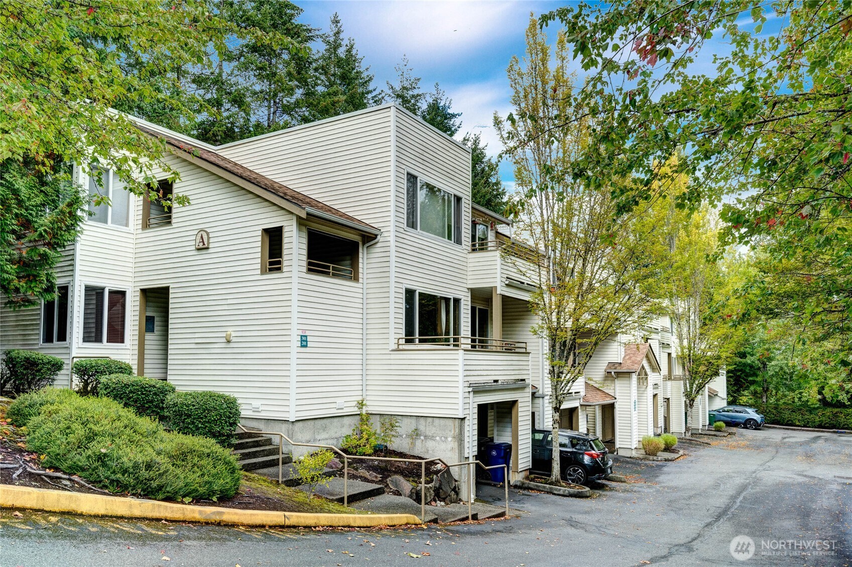 7583 Old Redmond Road, Unit A203 Redmond, WA 98052 - Photo 3 of 29 a view of a white house with large windows and large tree