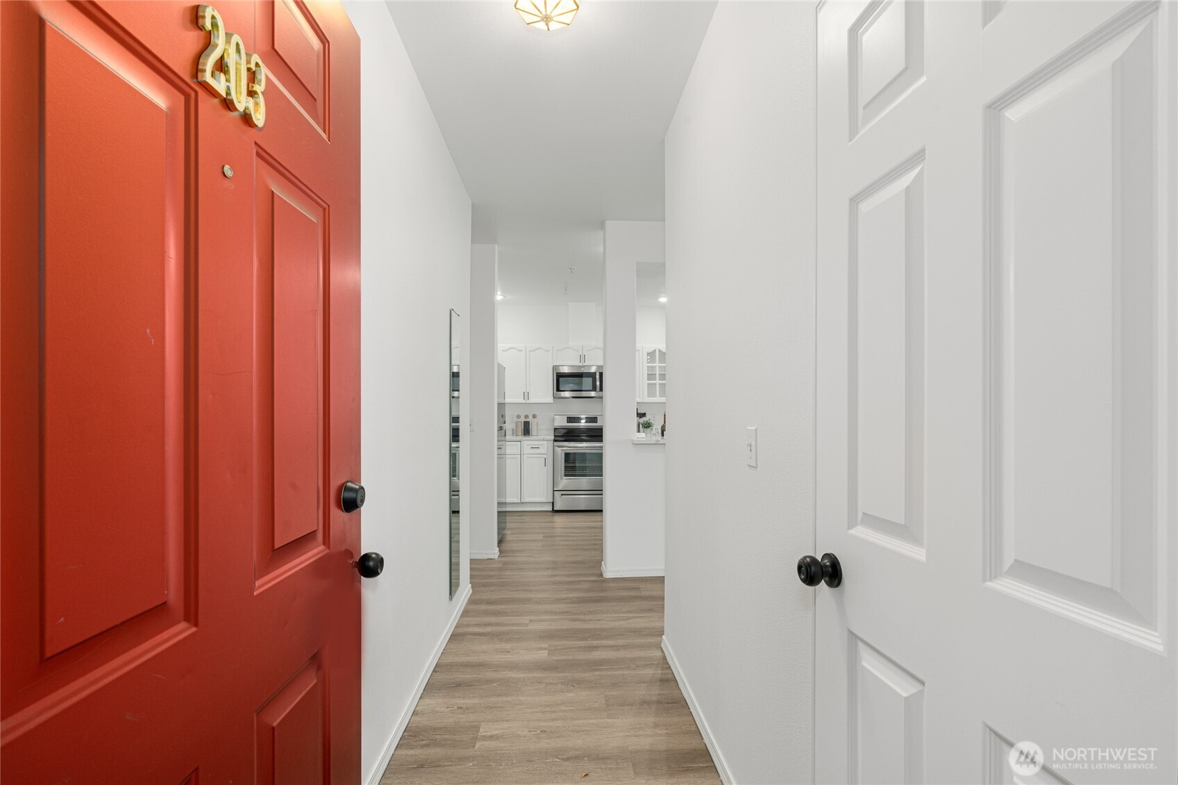 7583 Old Redmond Road, Unit A203 Redmond, WA 98052 - Photo 4 of 29 a view of a hallway with wooden floor and closet