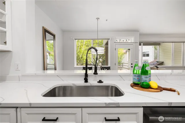 a kitchen with a sink and a large window