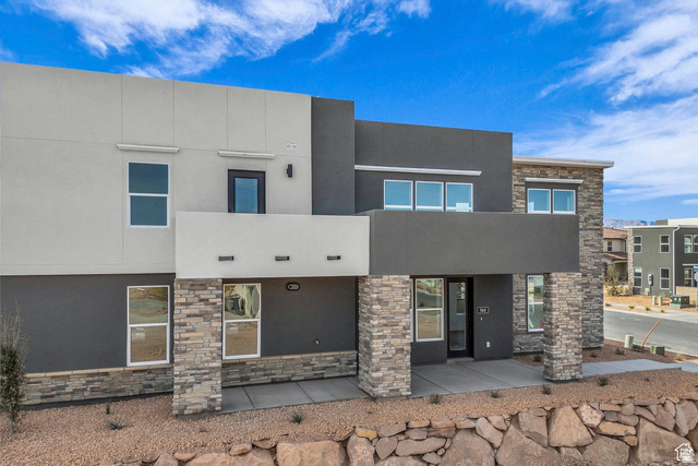 560 Aqua Cove St. George, UT 84790 - Photo 2 of 27 View of front of property with stucco siding and stone siding