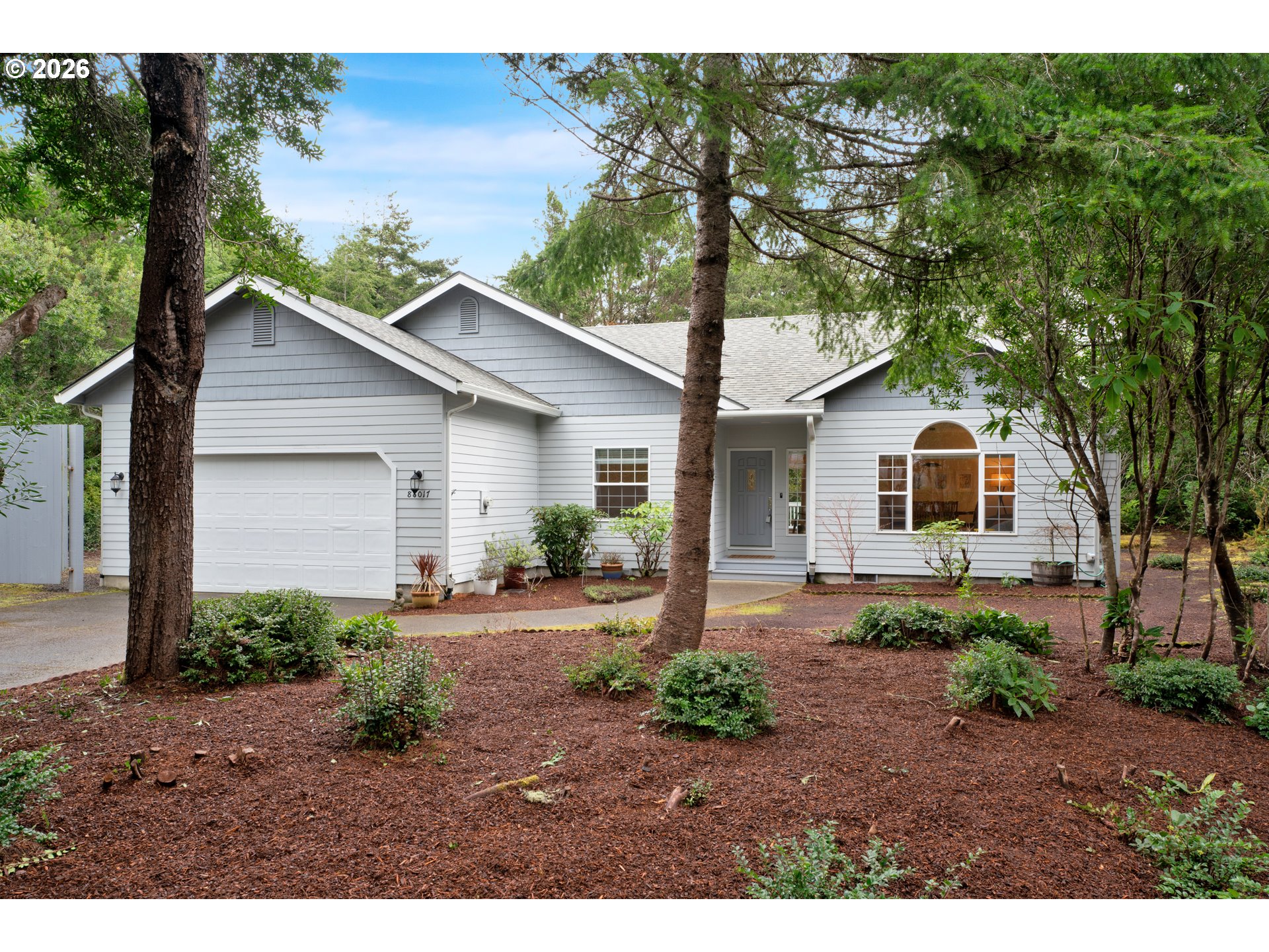 88017 South Wind Jammer Street Florence, OR 97439 - Photo 1 of 48 a front view of a house with a yard and garage