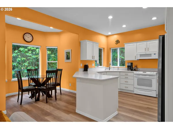 a kitchen with a table chairs and sink