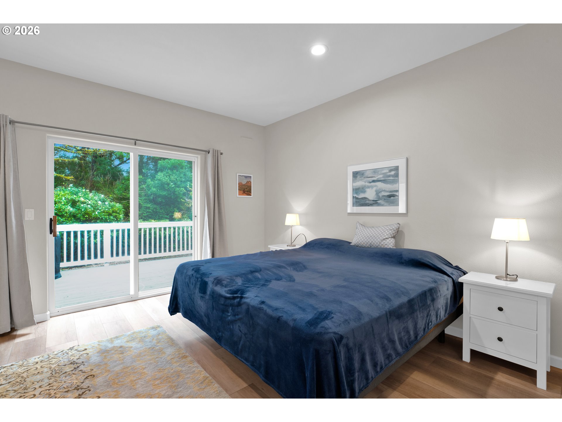 88017 South Wind Jammer Street Florence, OR 97439 - Photo 26 of 48 a bedroom with a bed a lamp and a large window