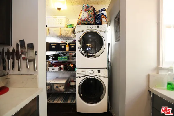 a view of a storage and utility room with washer and dryer