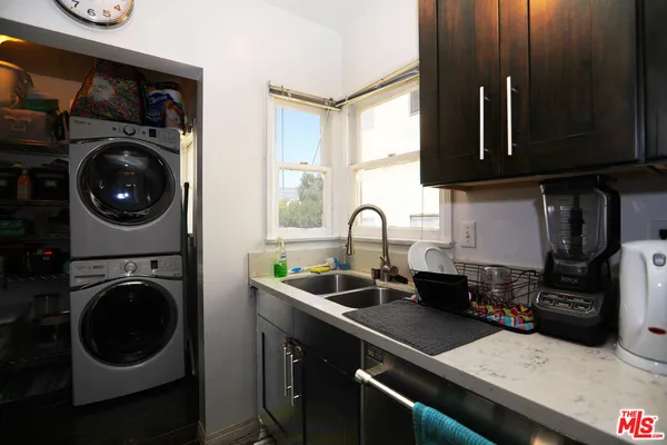 a kitchen with a sink a stove and cabinets