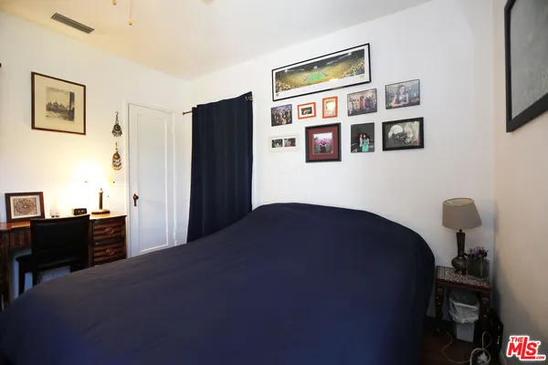 a bedroom with a bed dresser and a window