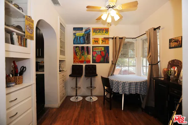 a dining room with furniture and wooden floor