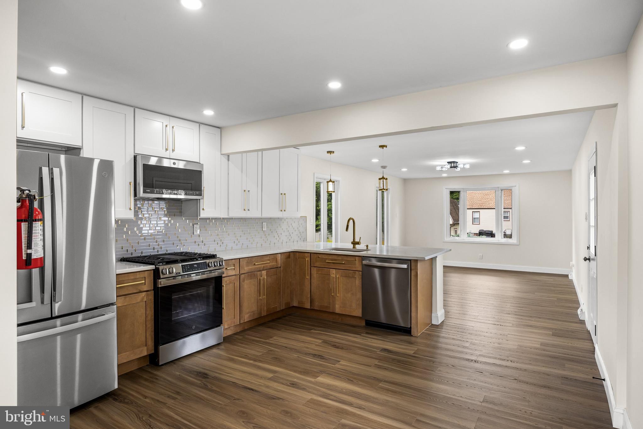 937 Clements Bridge Road Barrington, NJ 08007 - Photo 13 of 34 a kitchen with stainless steel appliances granite countertop a refrigerator a stove top oven a sink and dishwasher