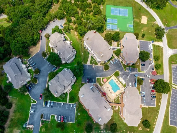 an aerial view of residential houses with outdoor space and river