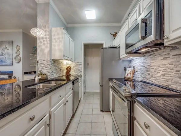 a kitchen with stainless steel appliances granite countertop a stove and a sink