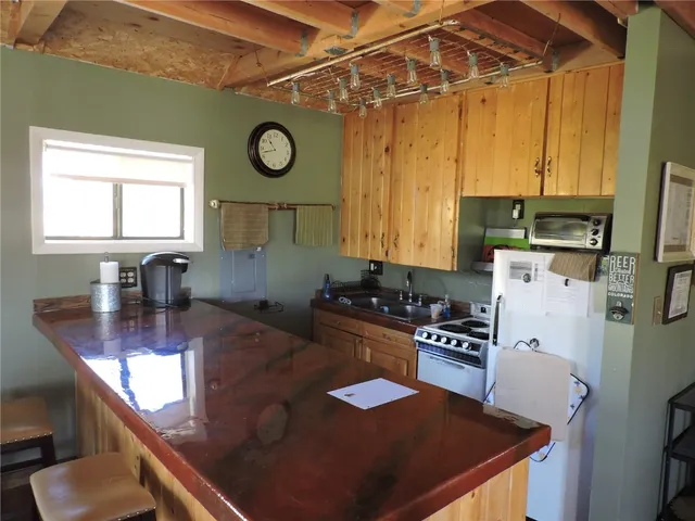a kitchen with sink refrigerator and stove