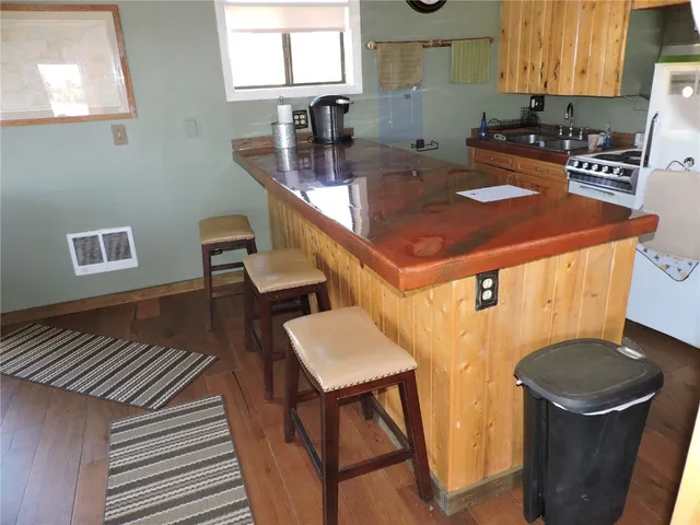 a kitchen with a sink a stove and a refrigerator