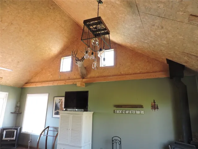 a view of a livingroom with furniture fridge and wooden floor