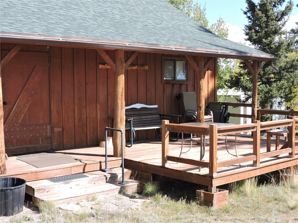 16 Buckshot Trail Como, CO 80432 - Photo 29 of 46 a view of a roof deck with wooden fence and a couple of chairs