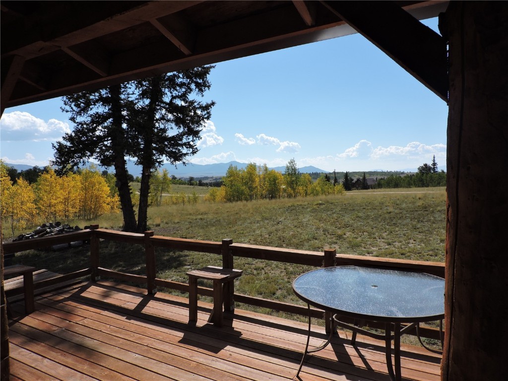 16 Buckshot Trail Como, CO 80432 - Photo 37 of 46 a view of a pool with a table and chairs under an umbrella