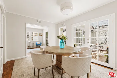 a dining room with furniture and wooden floor