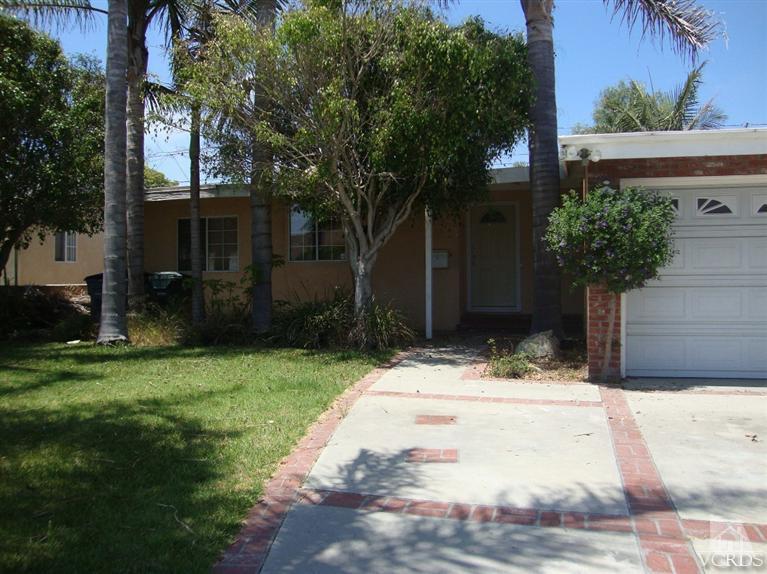 925 Rialto Street Oxnard, CA 93035 - Photo 4 of 20 a view of white house with a yard and tree s