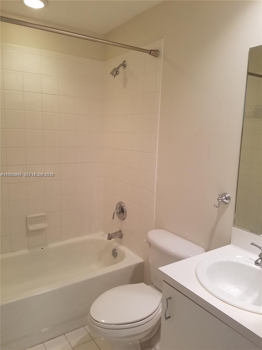 18741 Southwest 25th Court Miramar, FL 33029 - Photo 16 of 32 a white toilet sitting next to a bath tub
