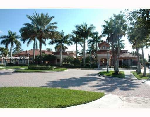 18741 Southwest 25th Court Miramar, FL 33029 - Photo 2 of 32 a palm tree sitting in front of a house with a yard