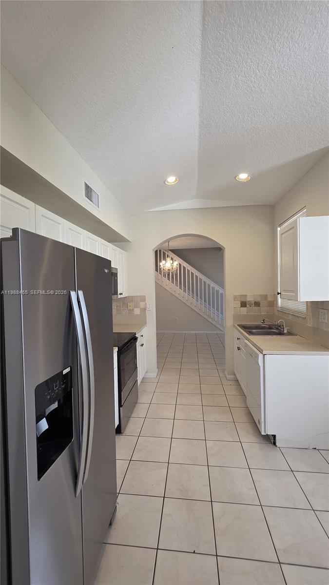 18741 Southwest 25th Court Miramar, FL 33029 - Photo 27 of 32 a kitchen with stainless steel appliances granite countertop a refrigerator and a stove