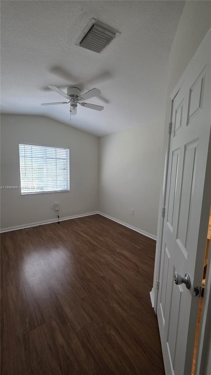 18741 Southwest 25th Court Miramar, FL 33029 - Photo 29 of 32 an empty room with wooden floor fan and windows
