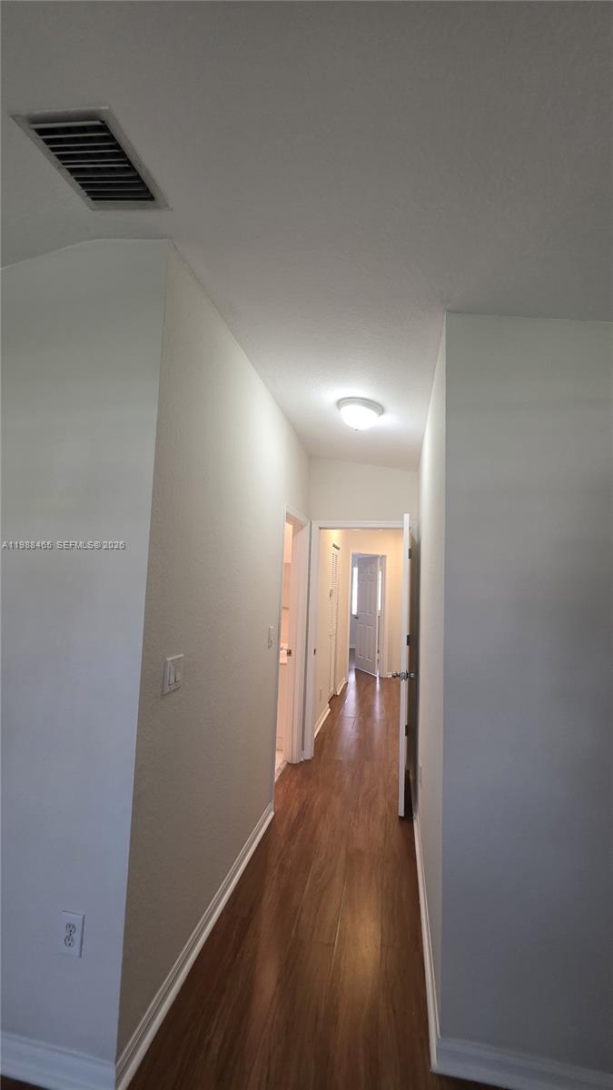 18741 Southwest 25th Court Miramar, FL 33029 - Photo 30 of 32 a view of a hallway with wooden floor